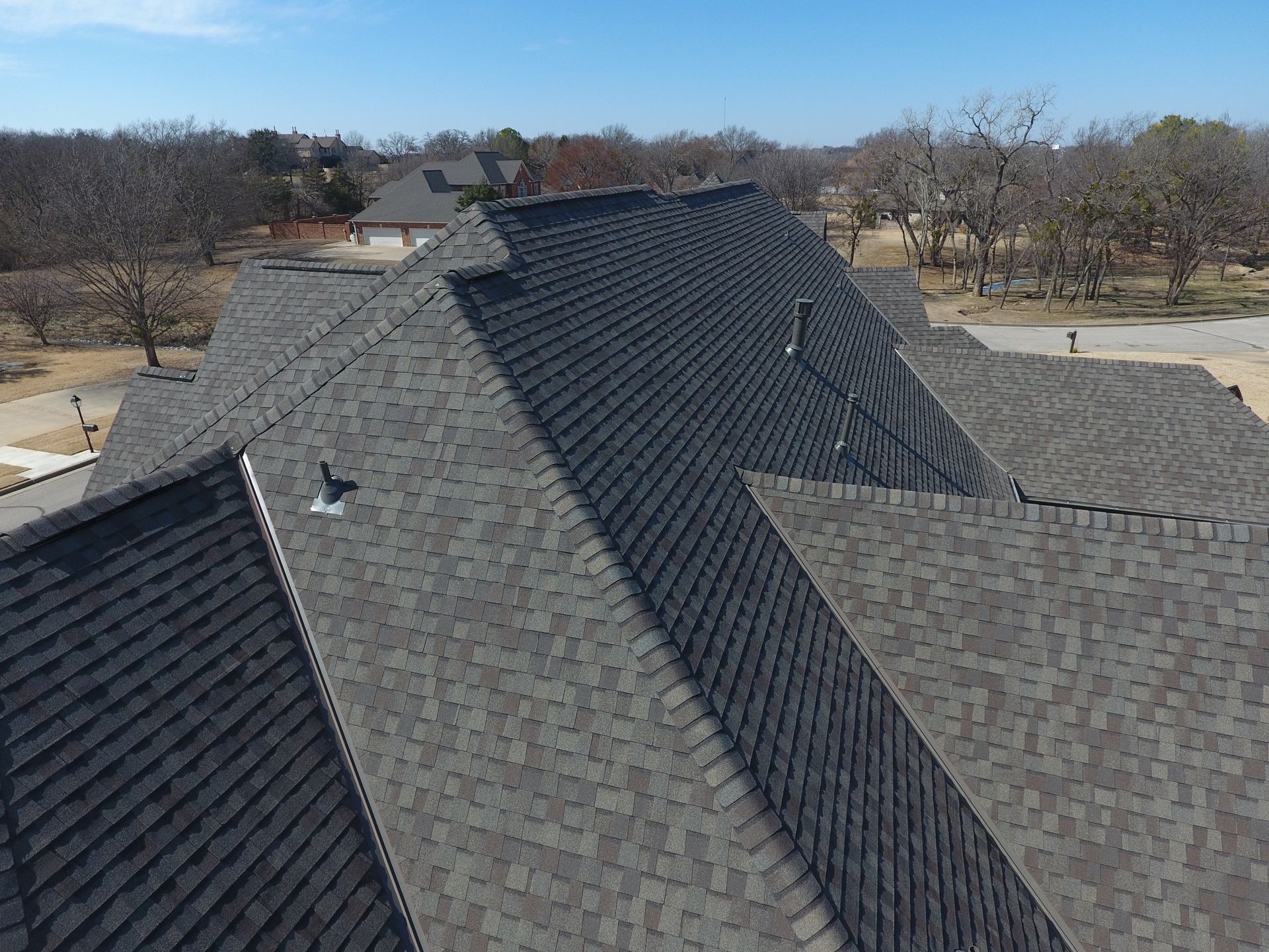 There is a chimney on the roof of a house.
