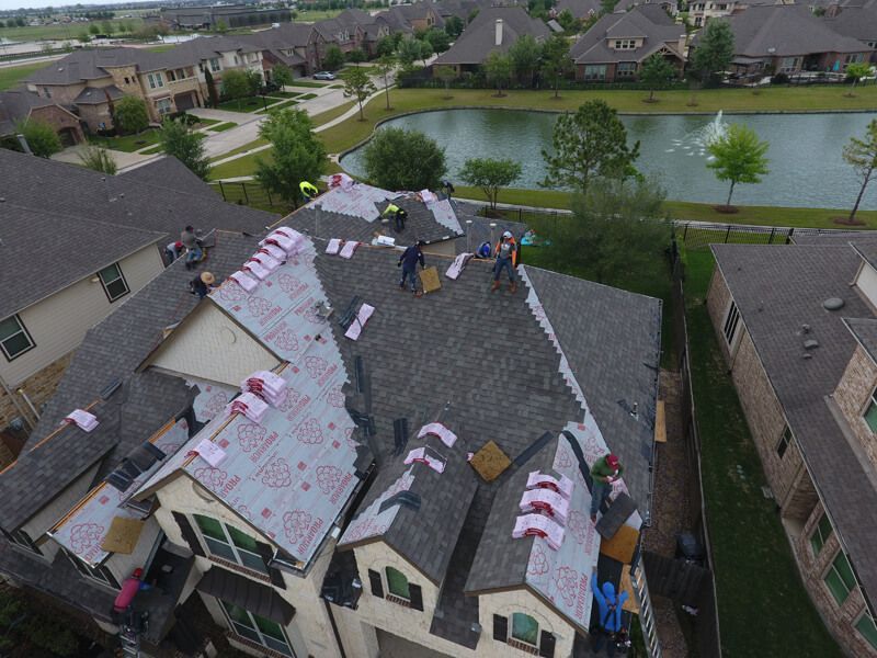 An aerial view of a roof being installed on a house.