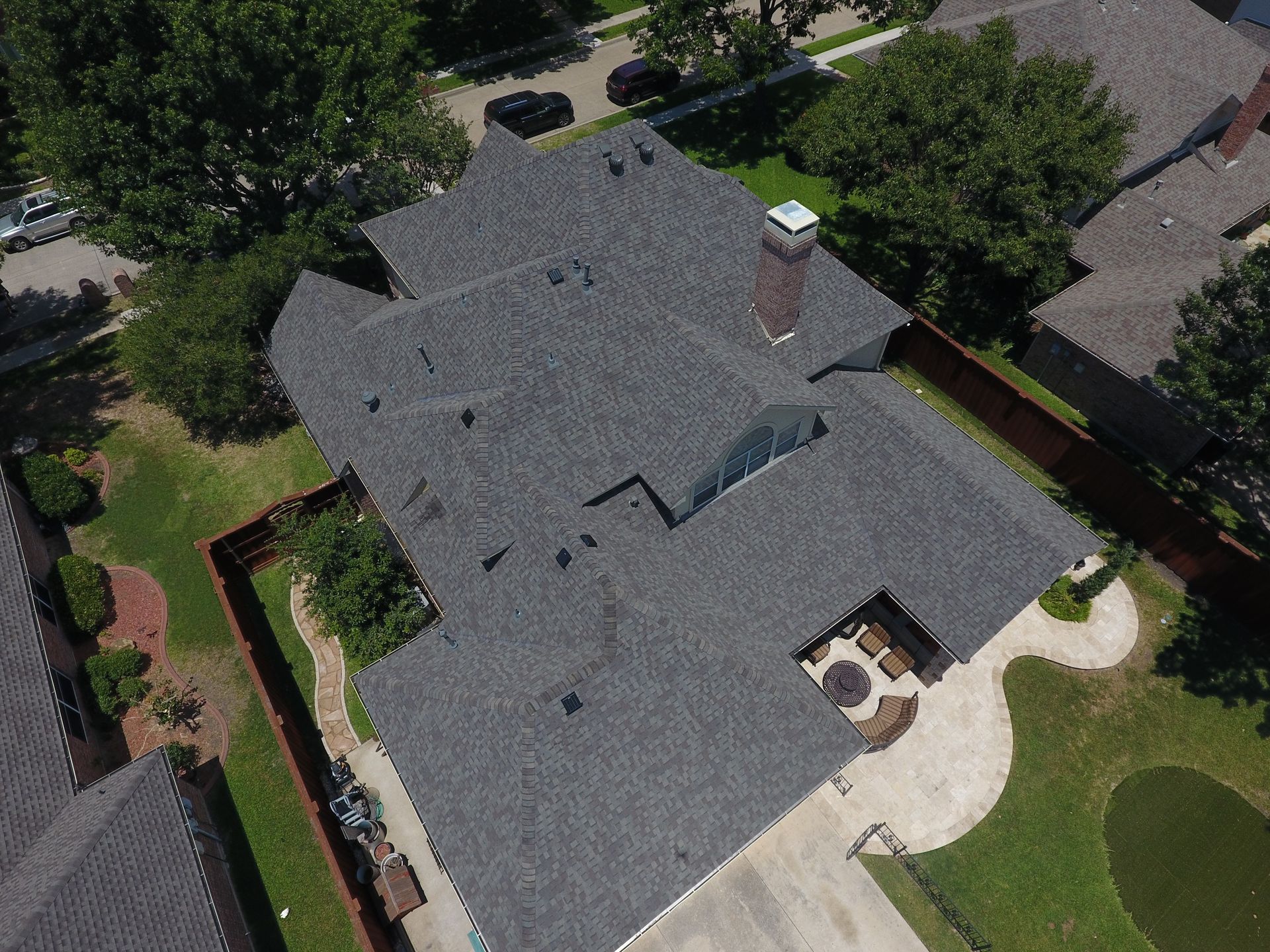 An aerial view of a house with a truck parked in front of it.