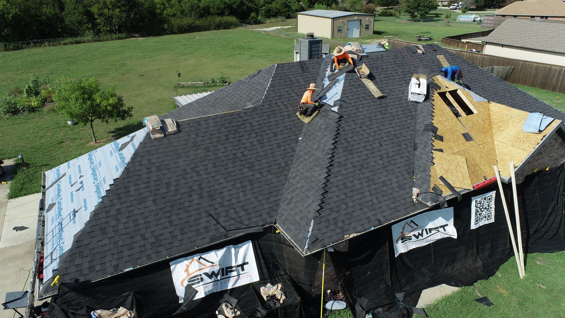An aerial view of a roof that is being repaired