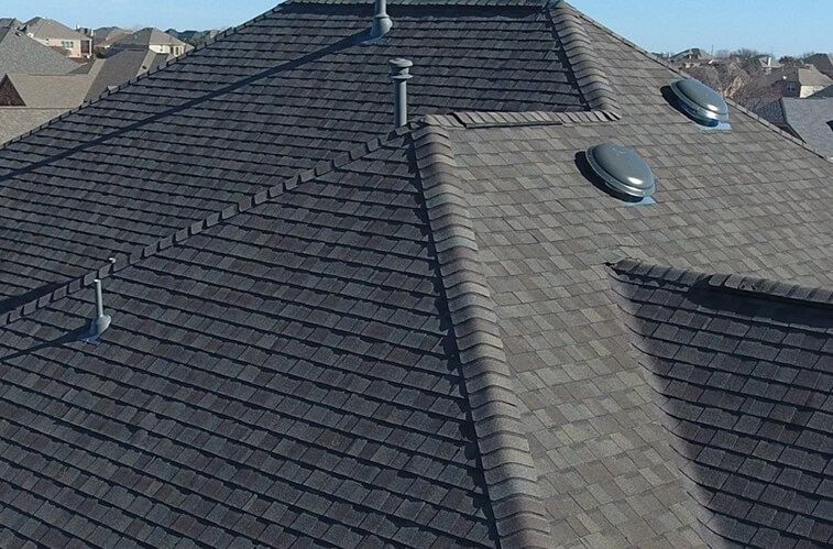 A roof with a lot of tiles and a chimney on it
