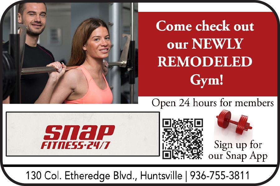 Gym advertisement: A woman squats with weights, guided by a man.