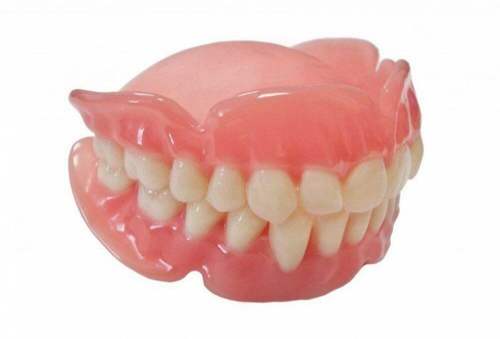 A Close up Of a Denture with White Teeth on A White Background — Cane to Coast Dentures in Sarina, QLD
