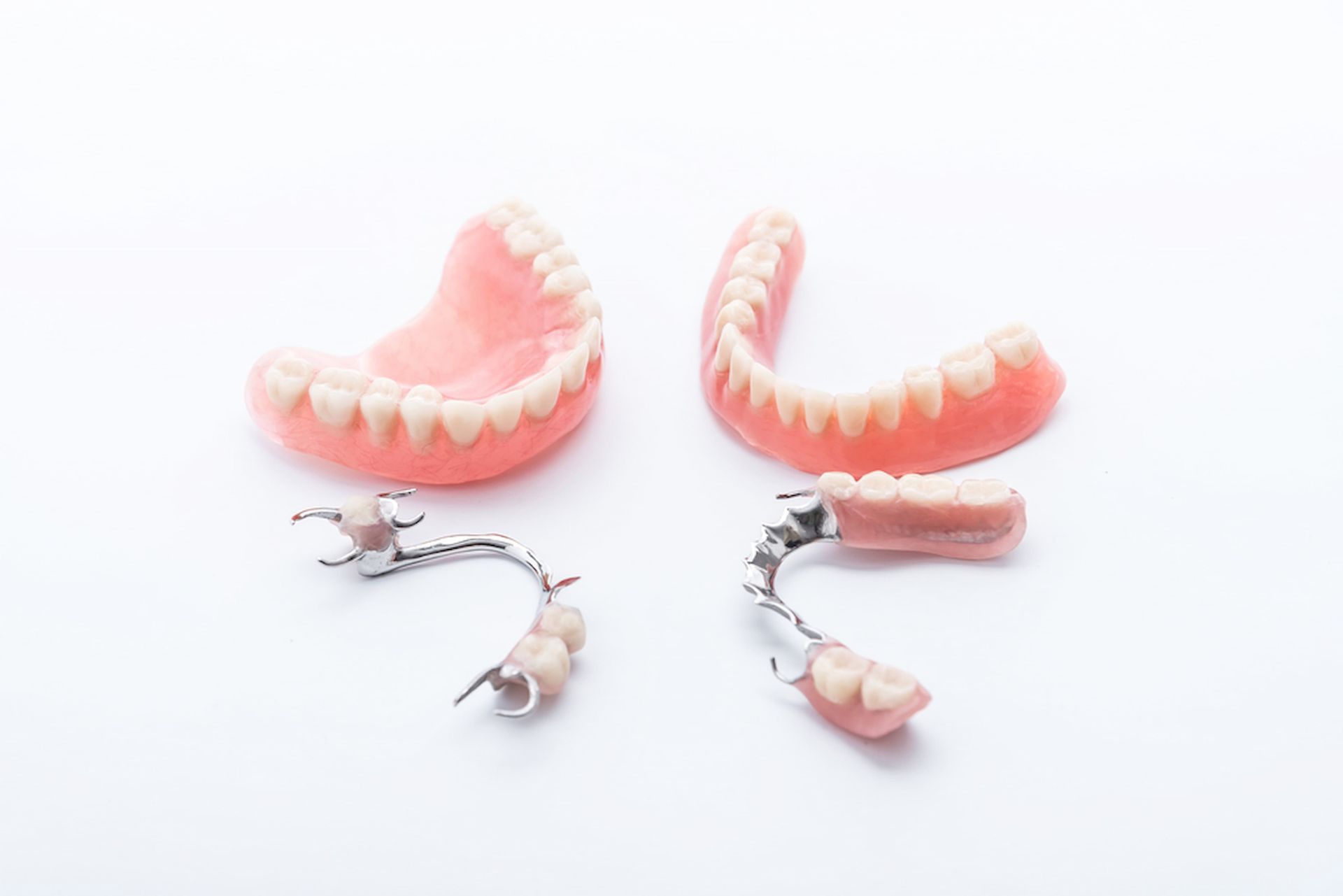 There Are Three Different Types of Dentures on A White Background — Cane to Coast Dentures in Sarina, QLD