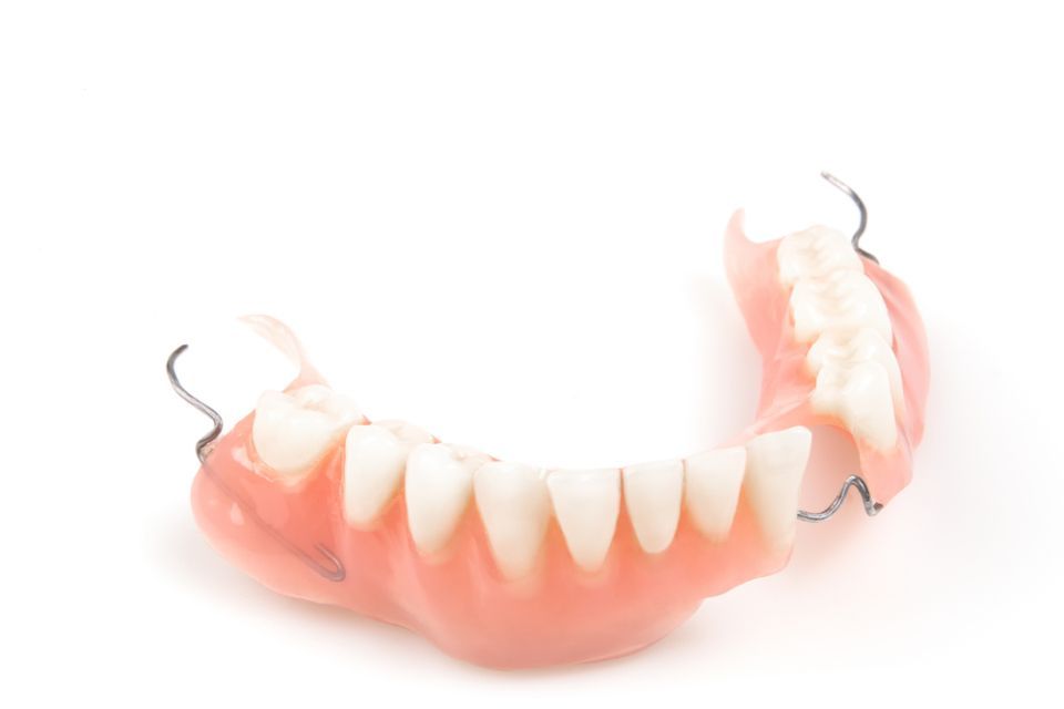 A Close up Of a Denture on A White Background — Cane to Coast Dentures in Sarina, QLD