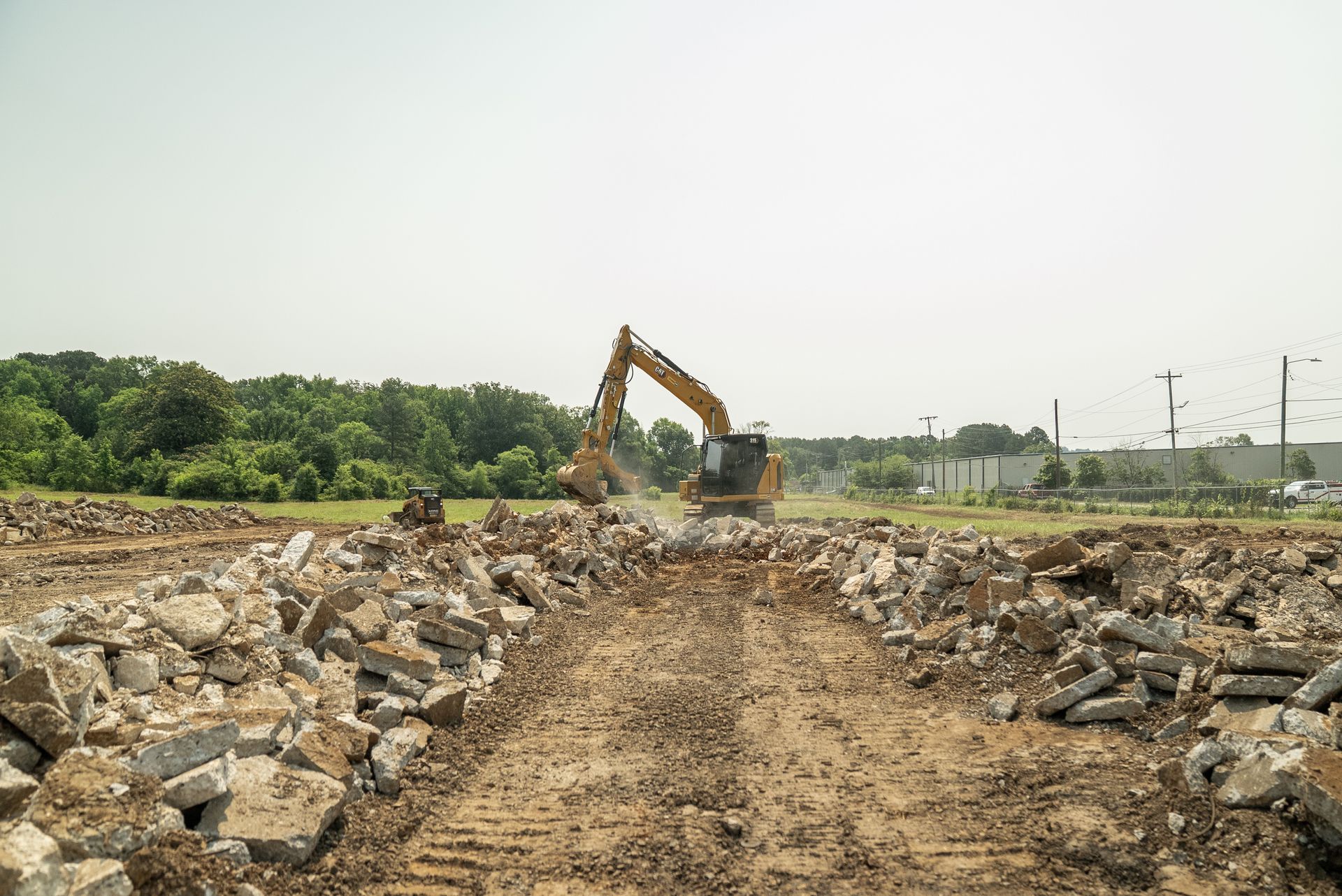 Excavator demolishing debris on a construction site.