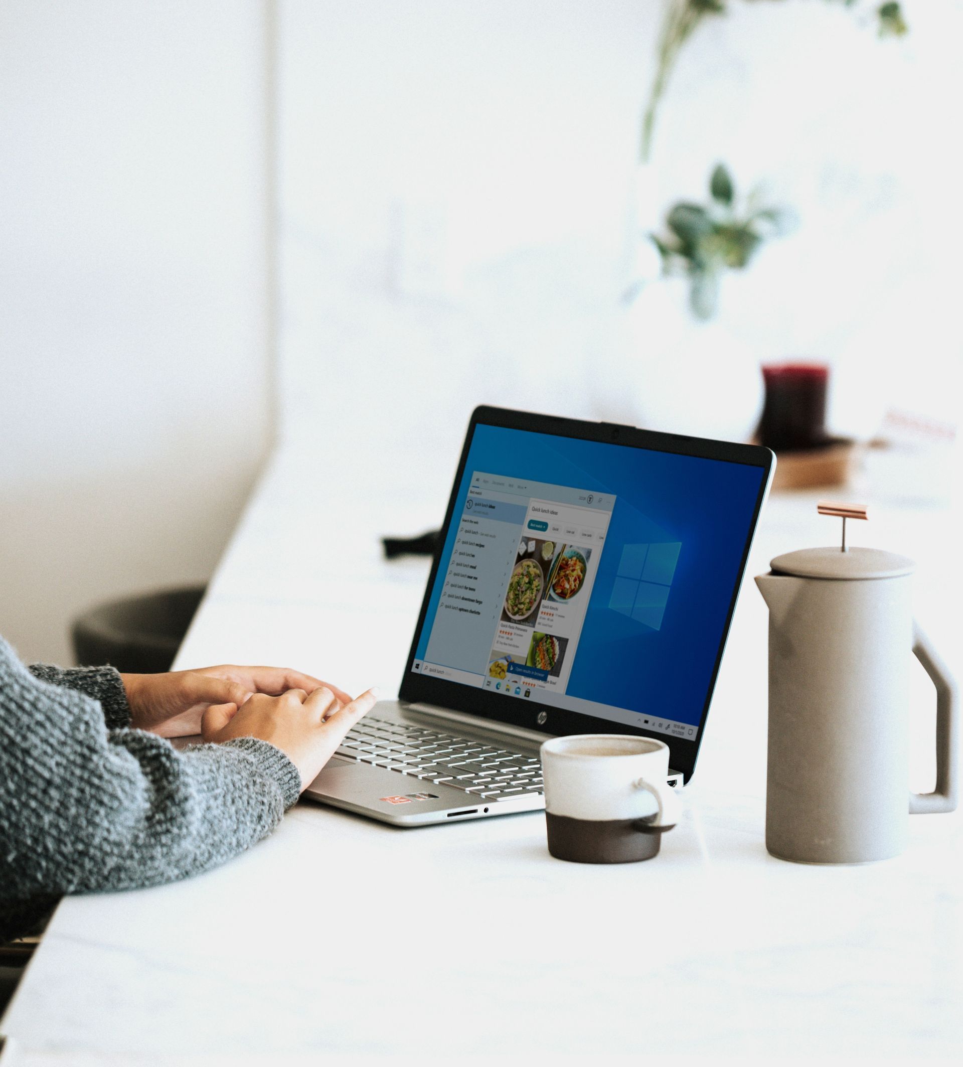 A person is sitting at a desk using a laptop computer.