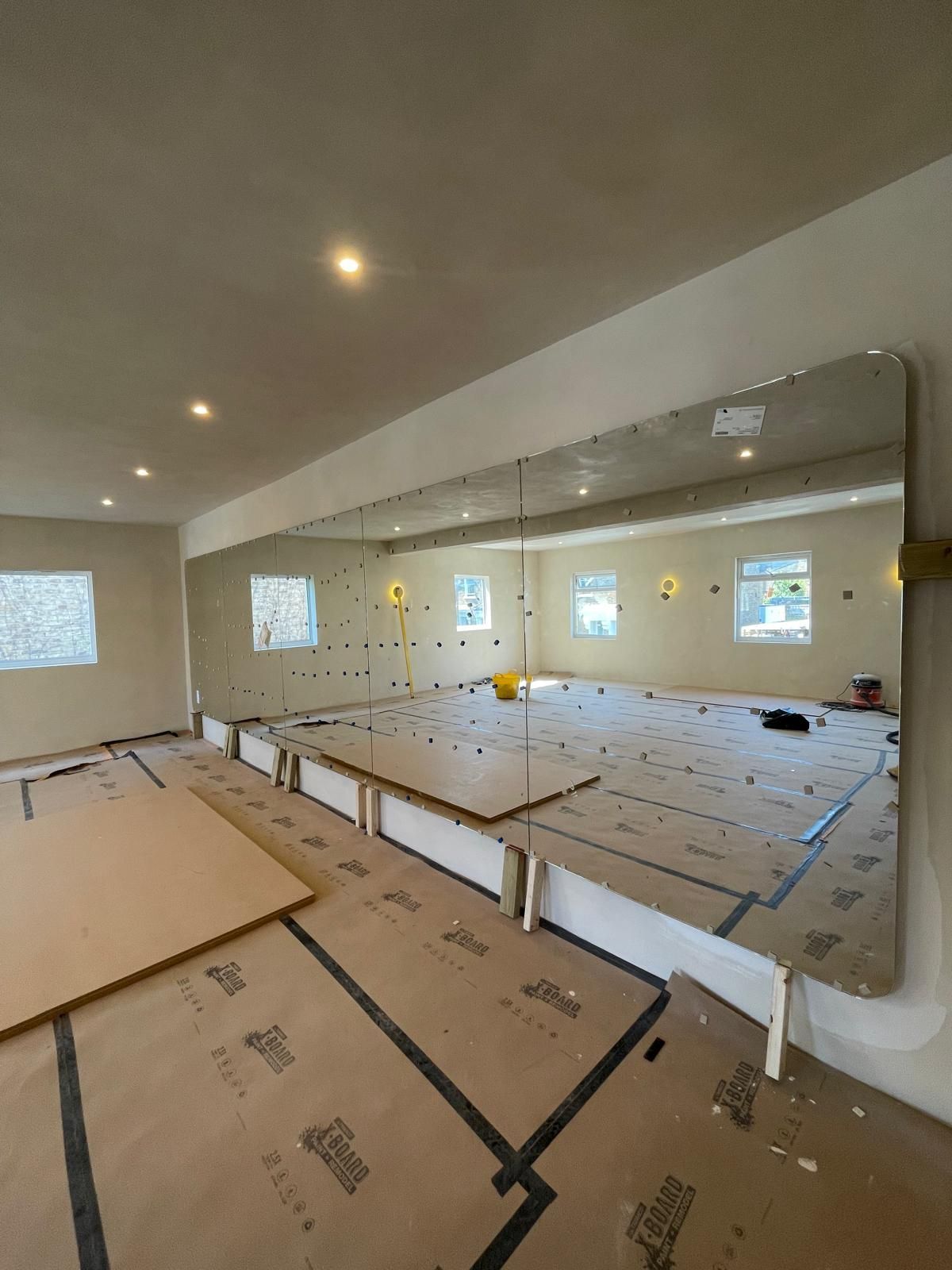 Backlit radius polished gym mirror