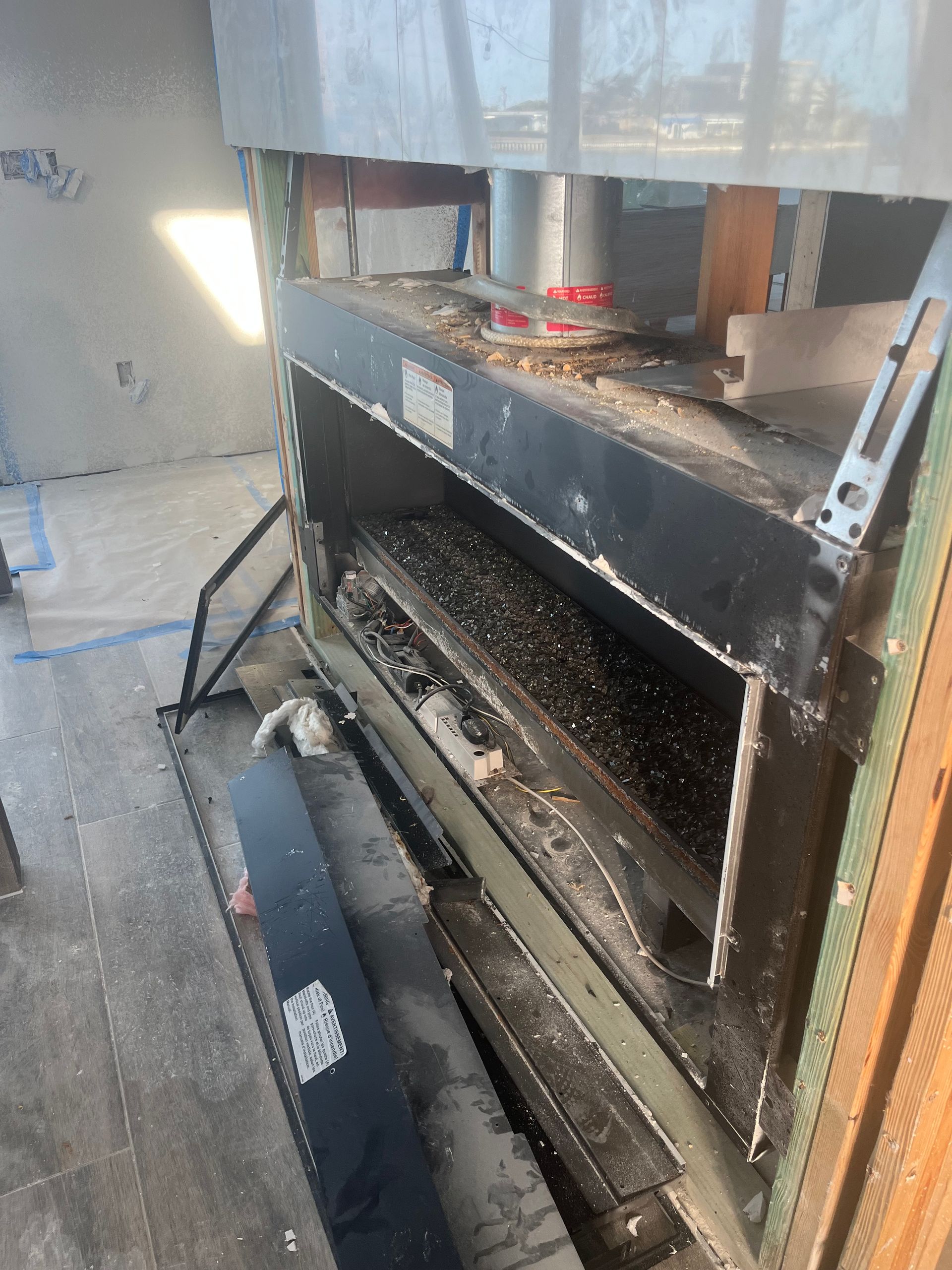 Large industrial oven with two levels, dirty, in a room with exposed framing.