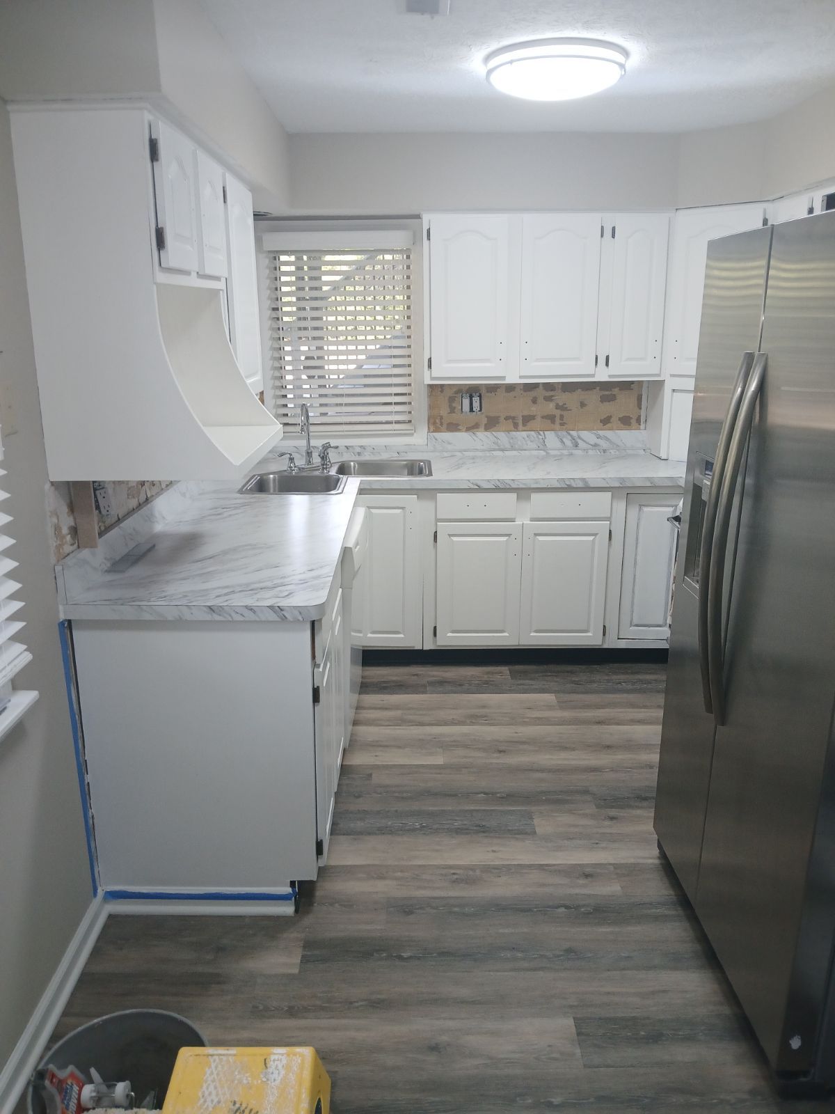 A kitchen with white cabinets and stainless steel appliances.
