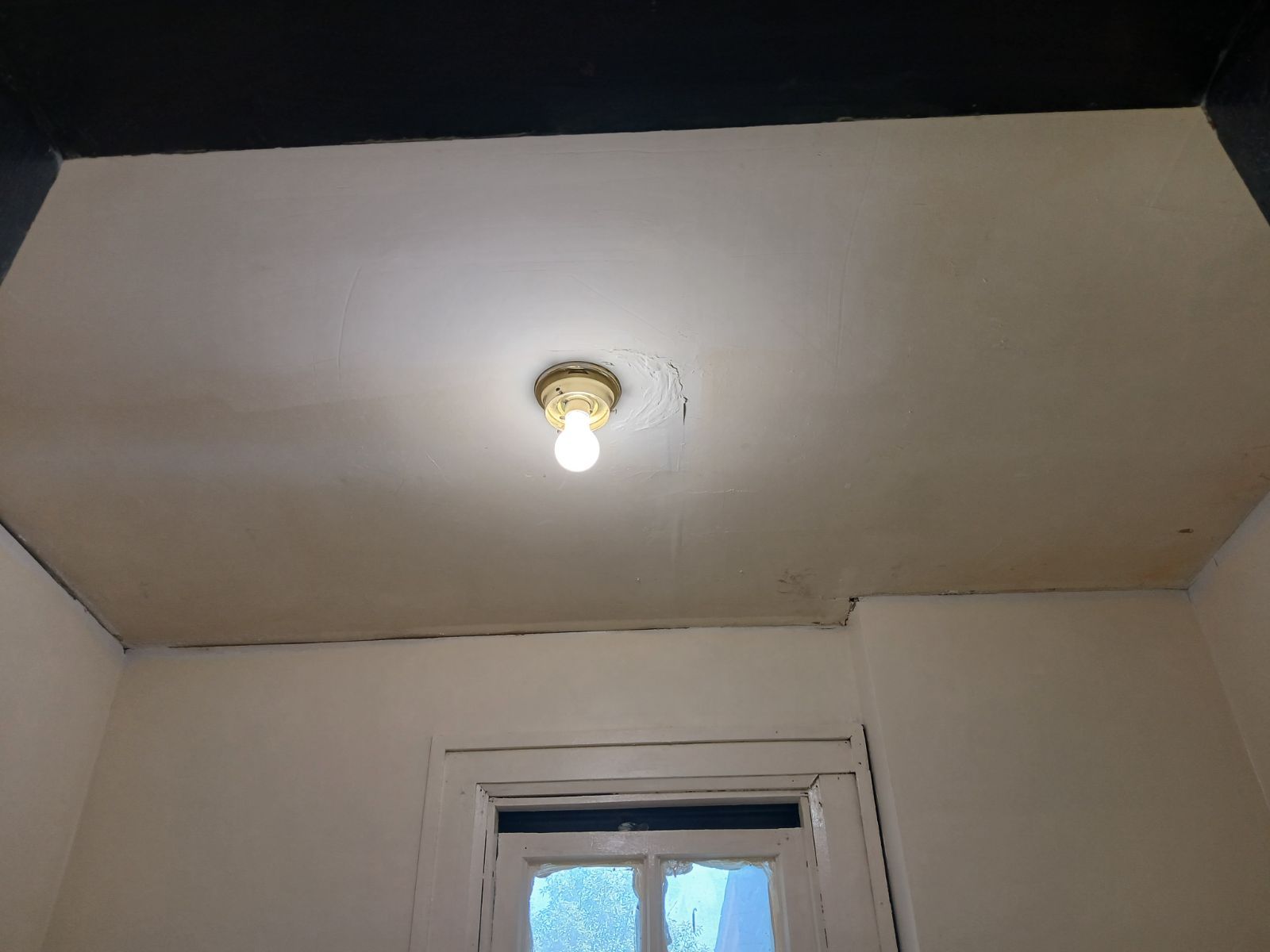 A light bulb is hanging from the ceiling of a room