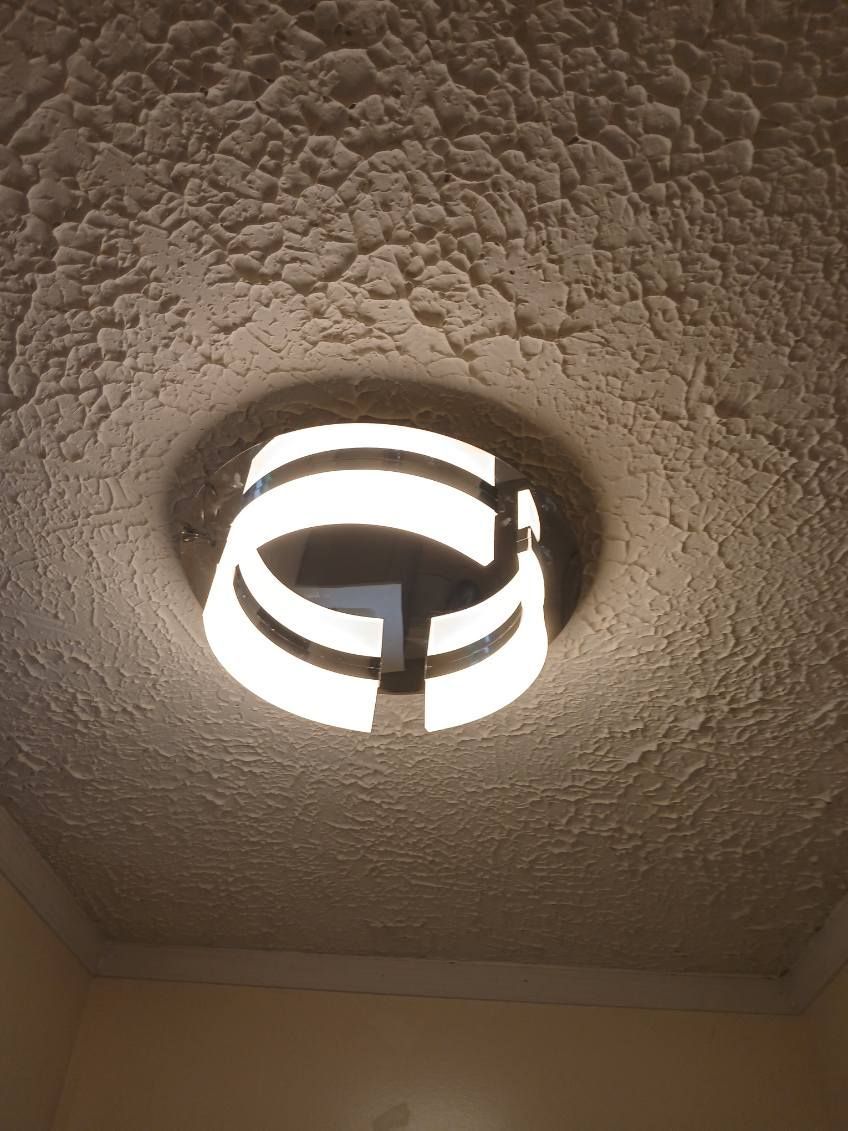 A light fixture is hanging from the ceiling of a room.