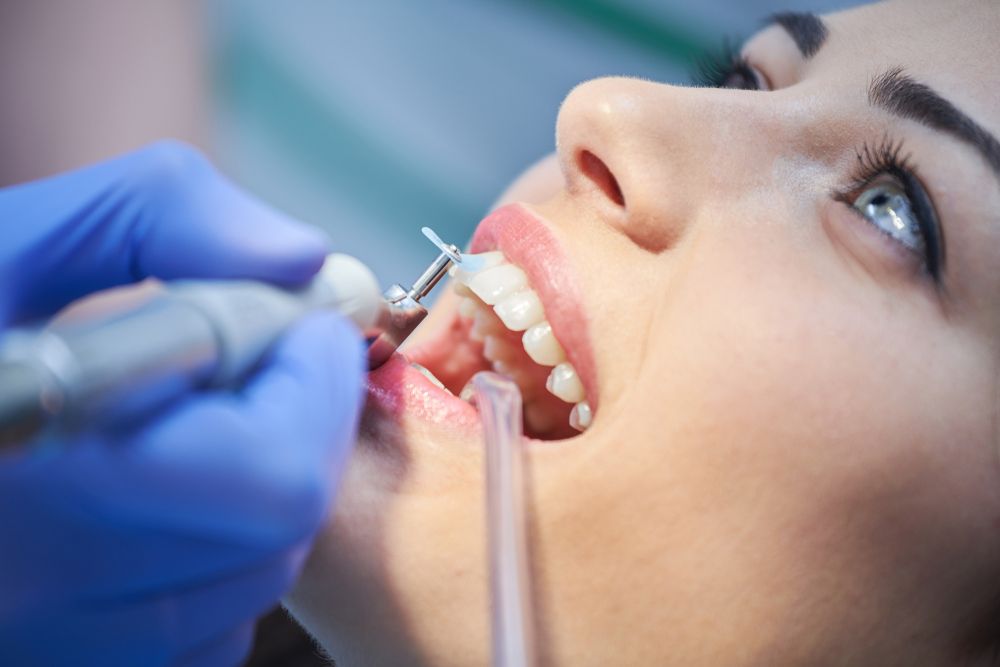 A Woman is Having Her Teeth Examined by a Dentist — Graham Johnson Dental Surgery In Beresfield, NSW
