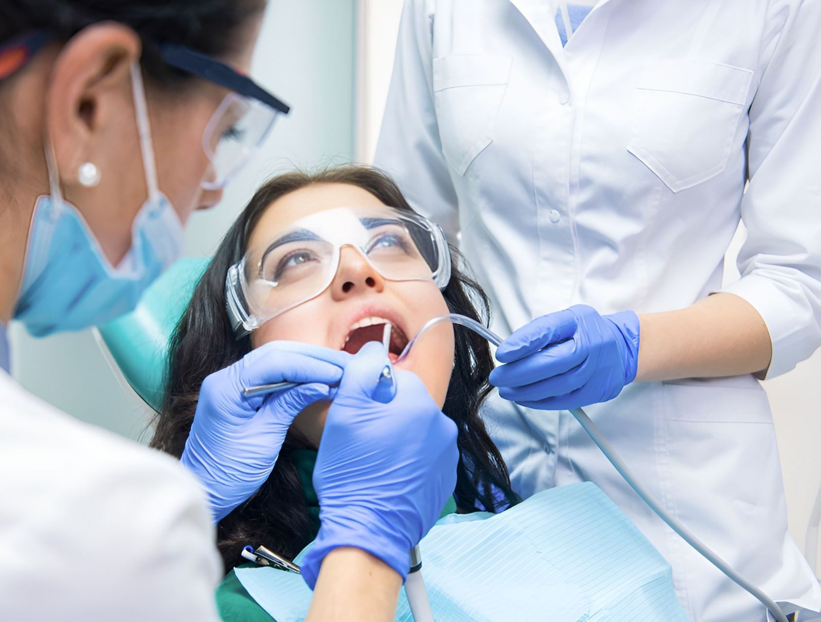 A Woman is Getting His Teeth Examined by a Dentist — Graham Johnson Dental Surgery In Jesmond, NSW