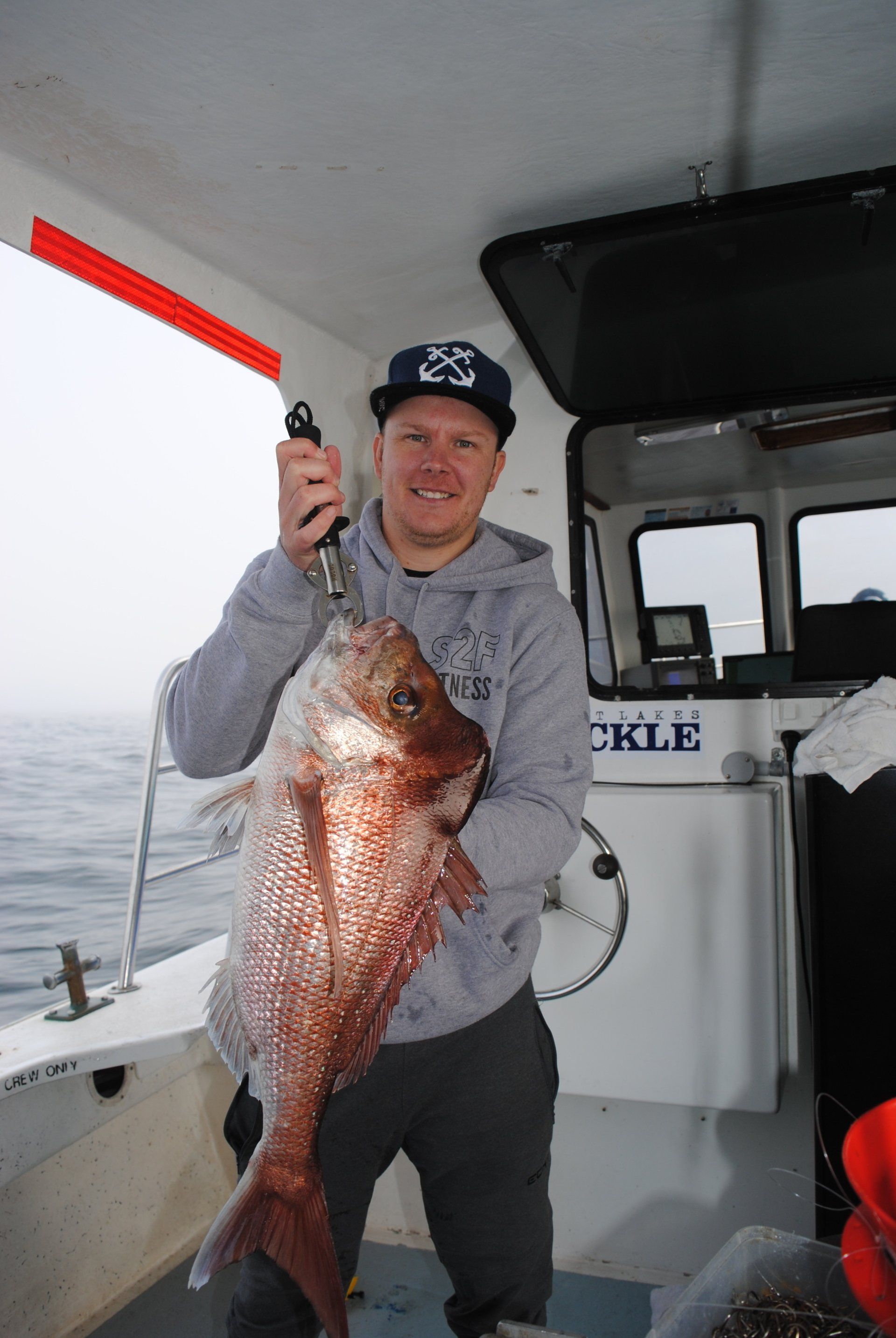 man holding a large red fish