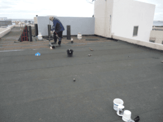 Worker using Torch-On Waterproofing — Wollongong, NSW — Longlife Waterproofing