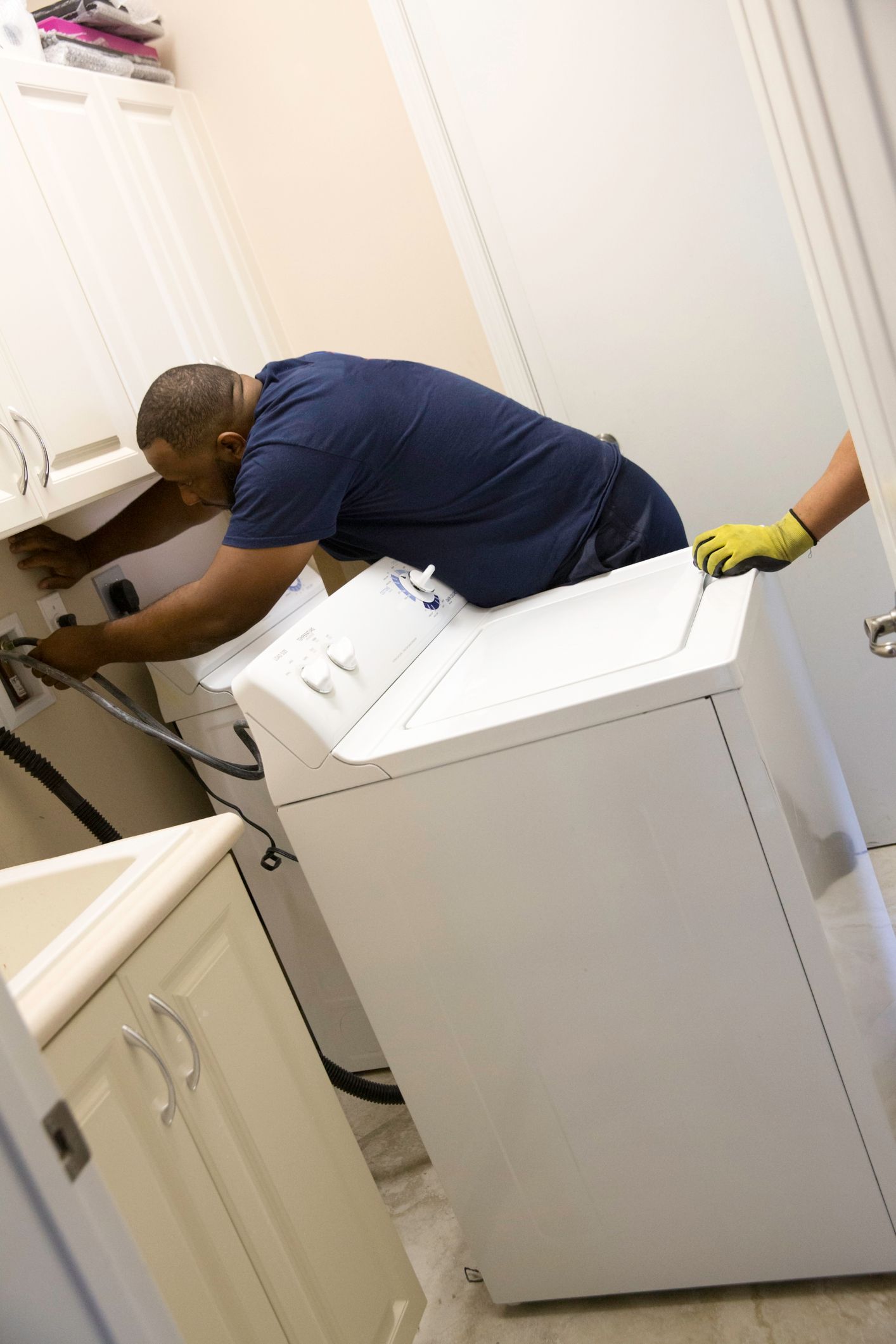 Removing Old Washer and Dryer In Laundry Room — Fairport, NY — Terry Rickner Appliance Service