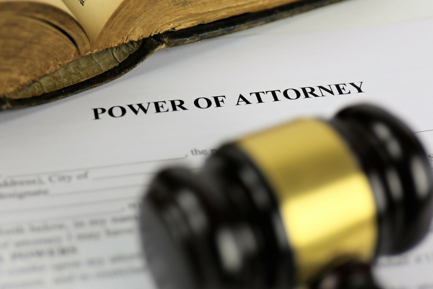 Power of Attorney document with a gavel and open book.