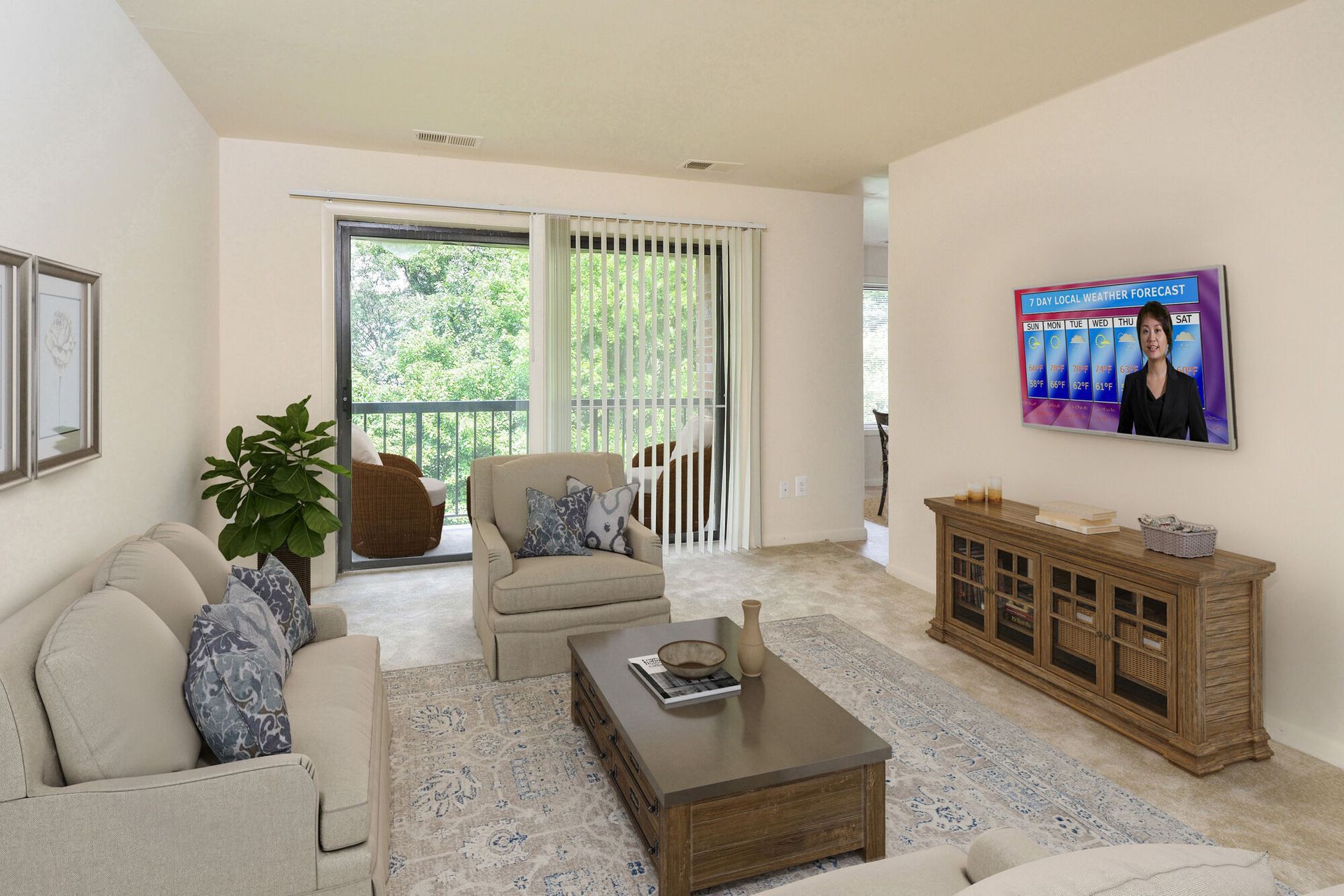 Living room in an apartment with beige sofa, coffee table, TV, and sliding balcony door.