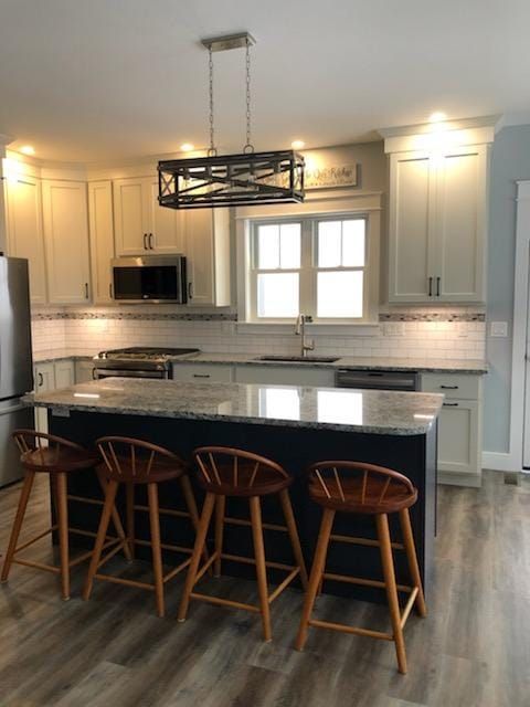 Beautiful kitchen with white cabinets and hanging pendants
