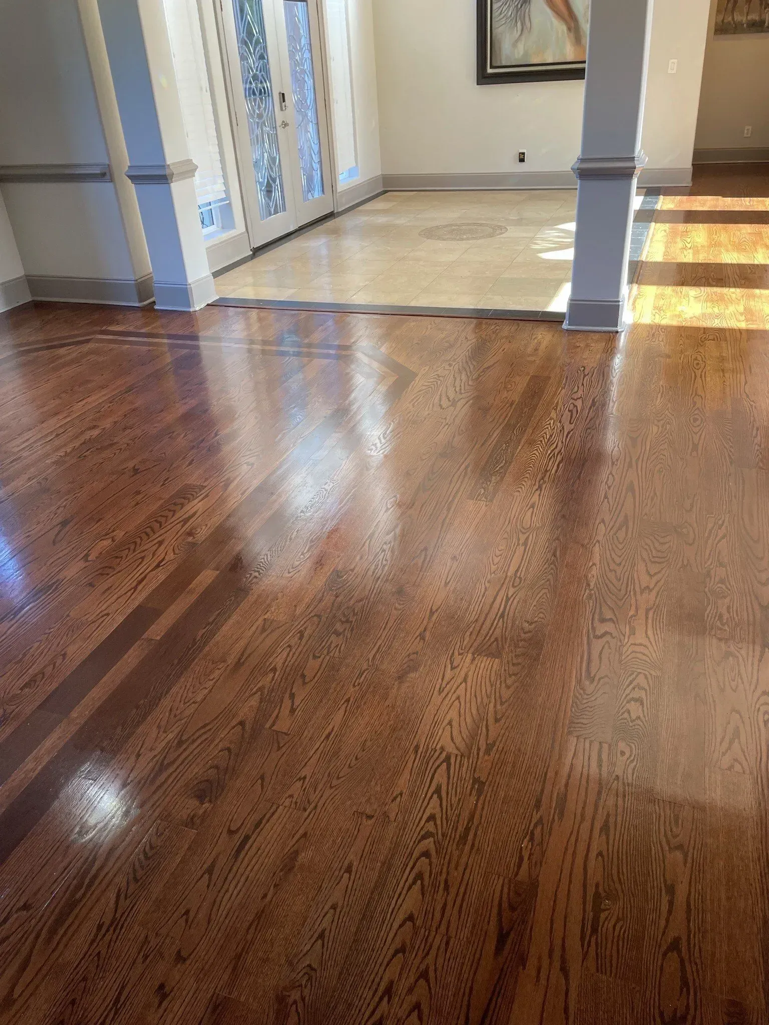 A living room with hardwood floors and a marble floor.