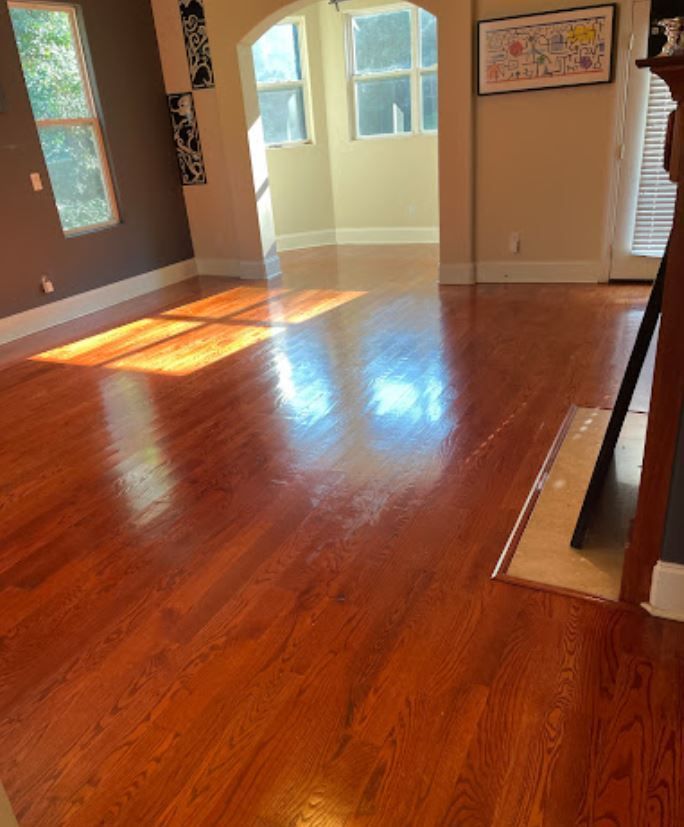A living room with hardwood floors and a fireplace