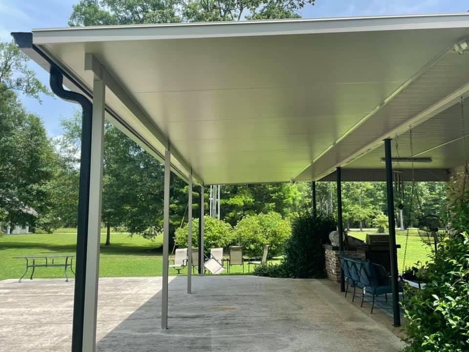 A carport with a roof that is covered with a white roof