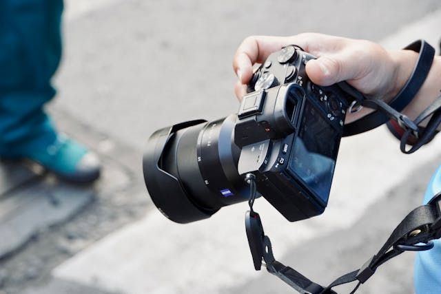A close up of someones hand holding a camera