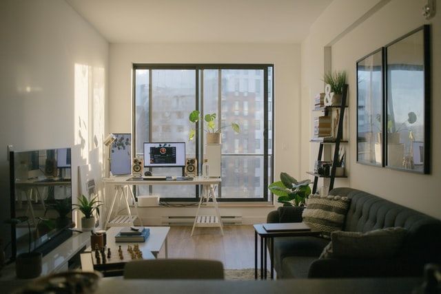 An apartment with a couch, tv, and home office