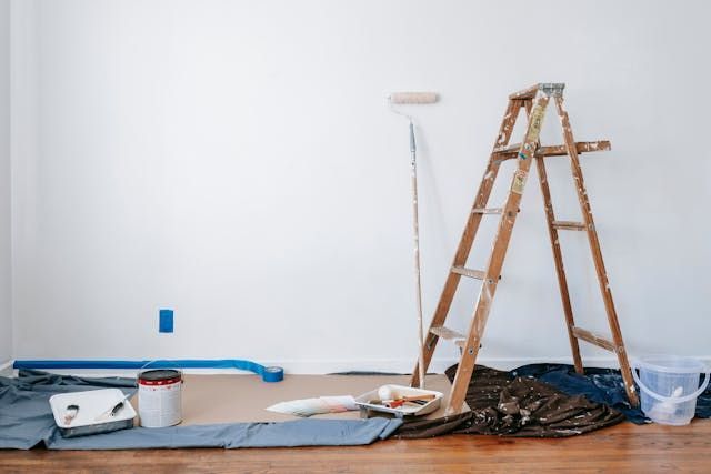 Ladder and paint supplies in a room