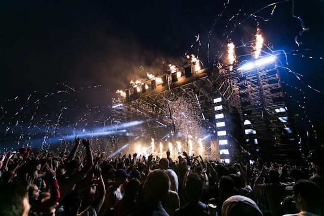 a crowd at a music festival at night