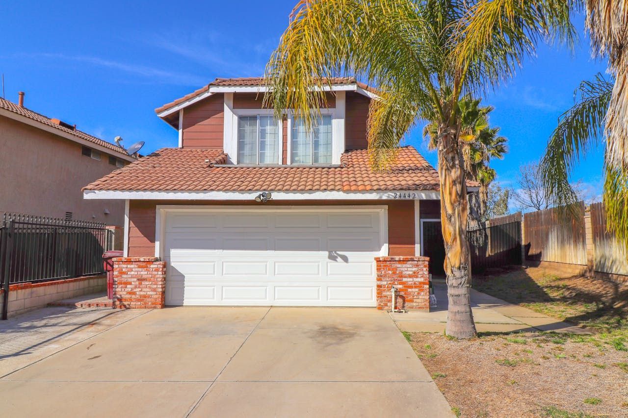 brown house with palm trees