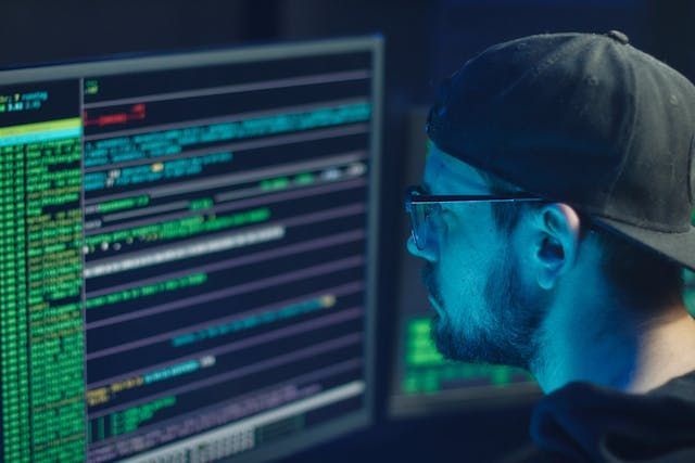a man coding in front of a computer