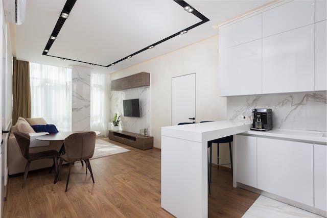 interior of a rental property with modern white kitchen finishes