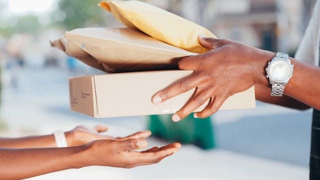 person handing someone a bunch of packages