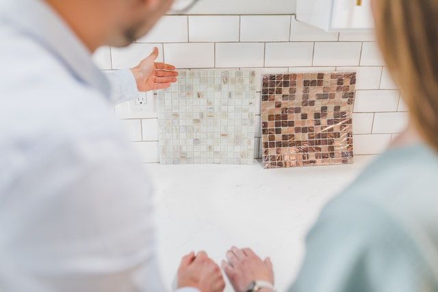 two people looking at two different backsplash options