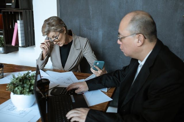 two property managers looking over documents during a meeting