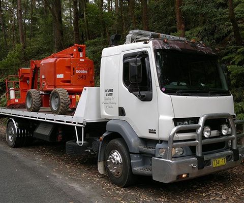 A Large Truck Carrying A Forklift — DJ’s Tilt Tray Service in Urunga NSW