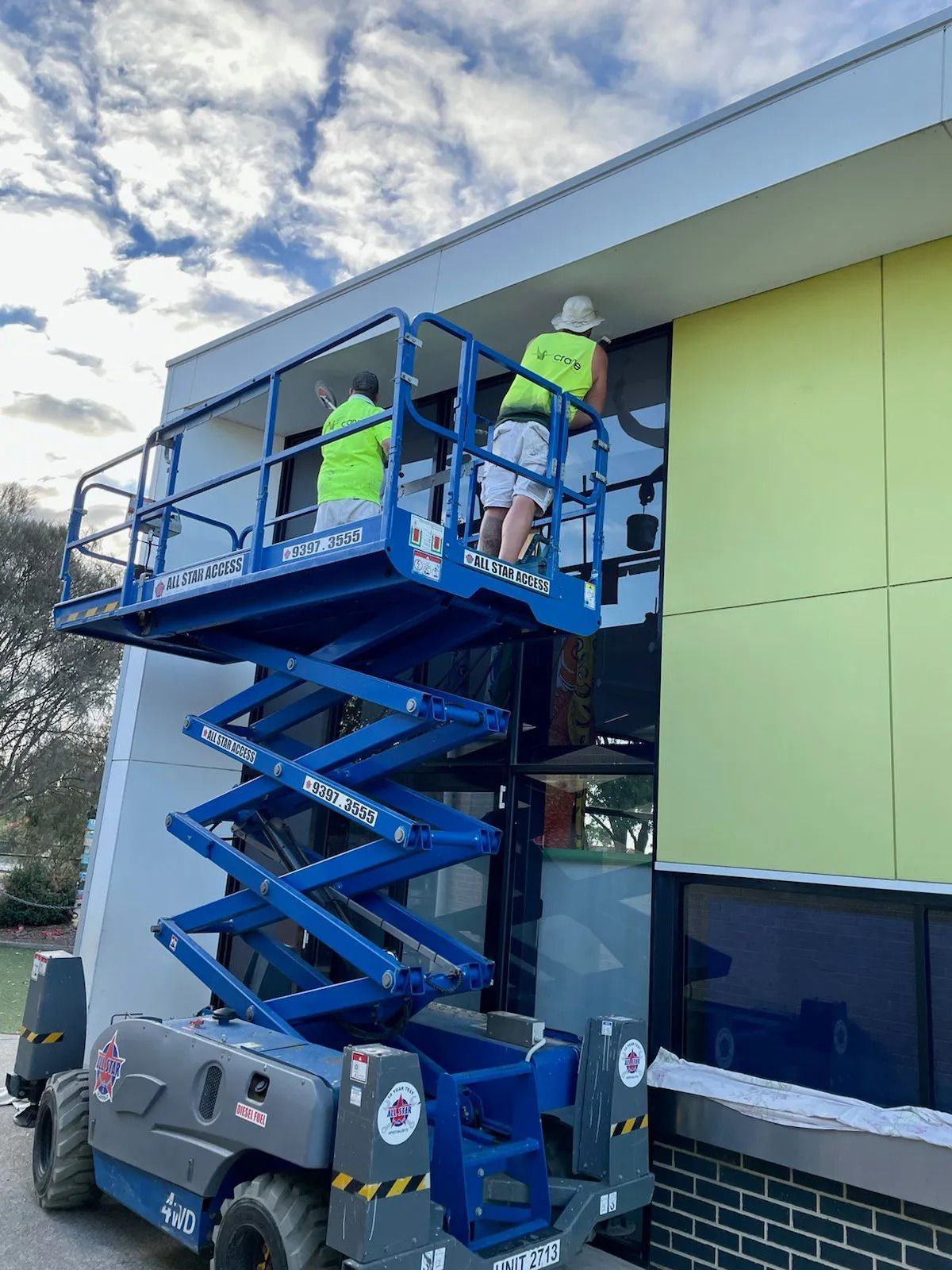Workers painting the office wall