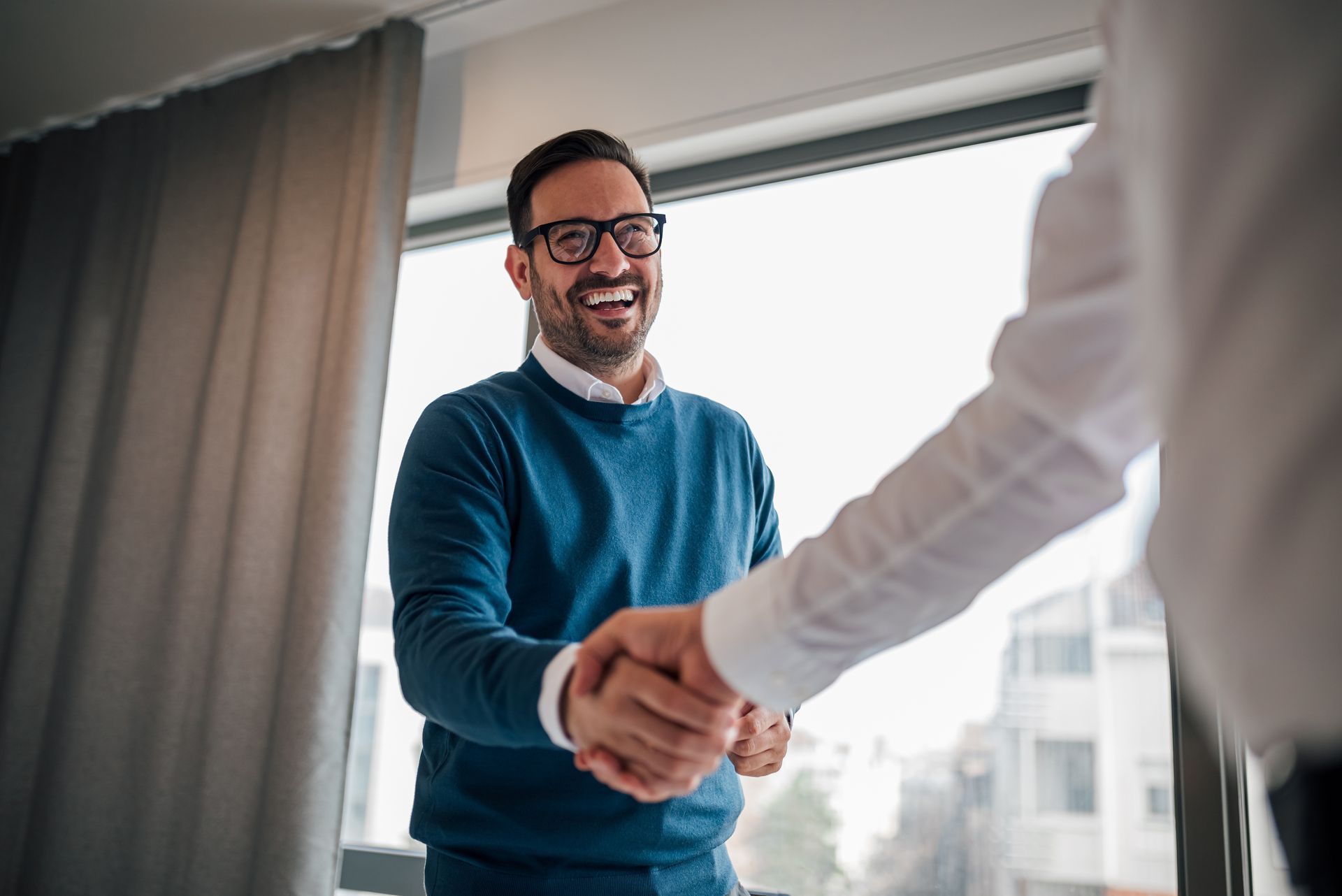 A man shaking hands happily