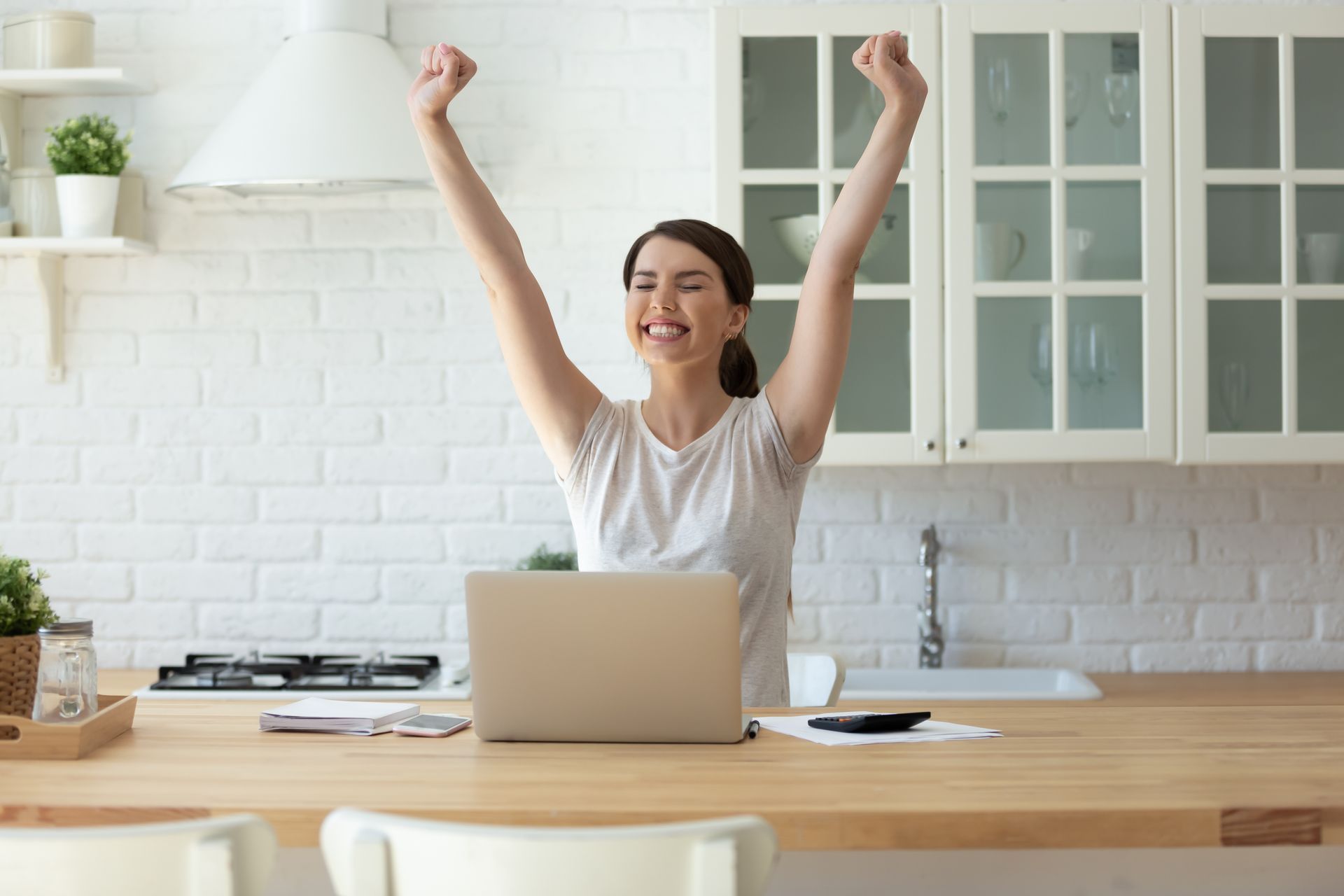 Woman happy raising both hands