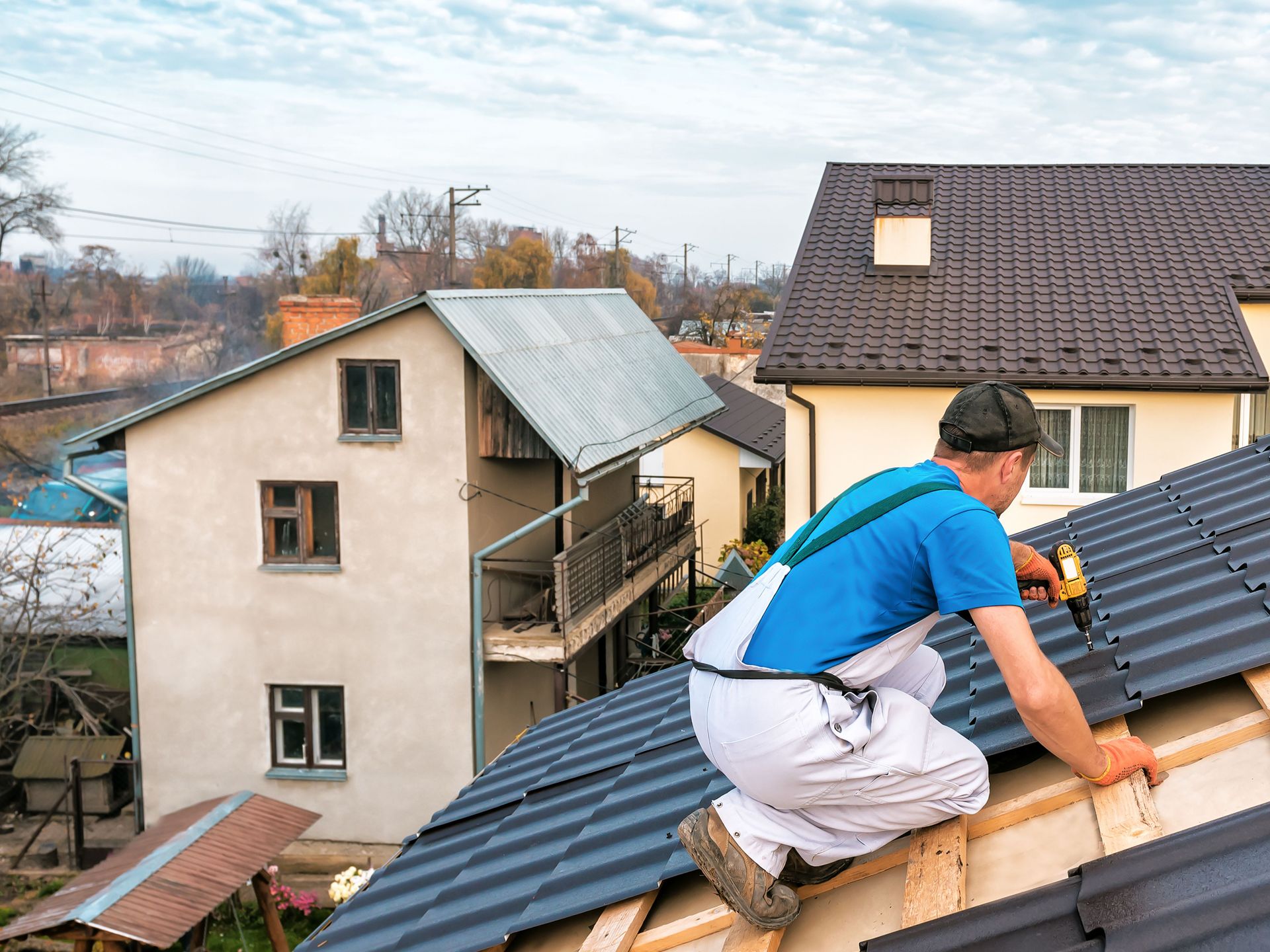 A man is working on the roof of a house.
