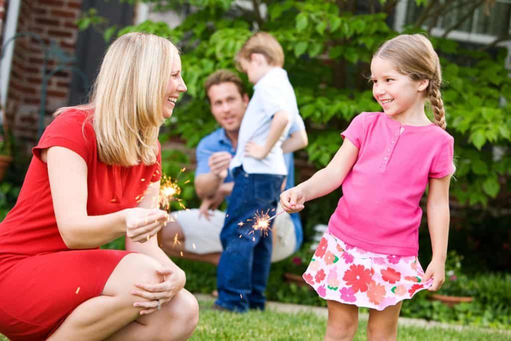 girl and mother enjoying sparklers