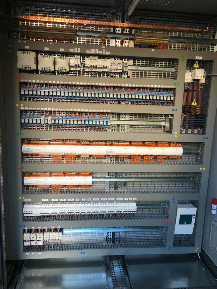 Un grand panneau de contrôle électrique rempli de nombreux équipements électriques.