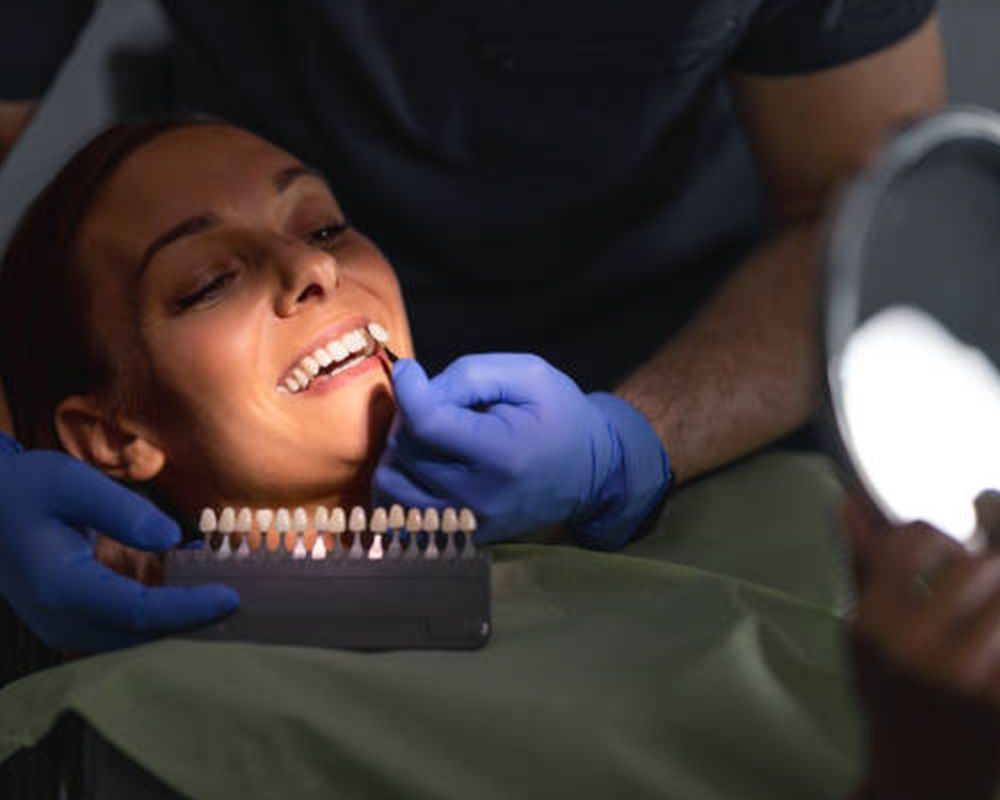 A patient getting professional teeth whitening services