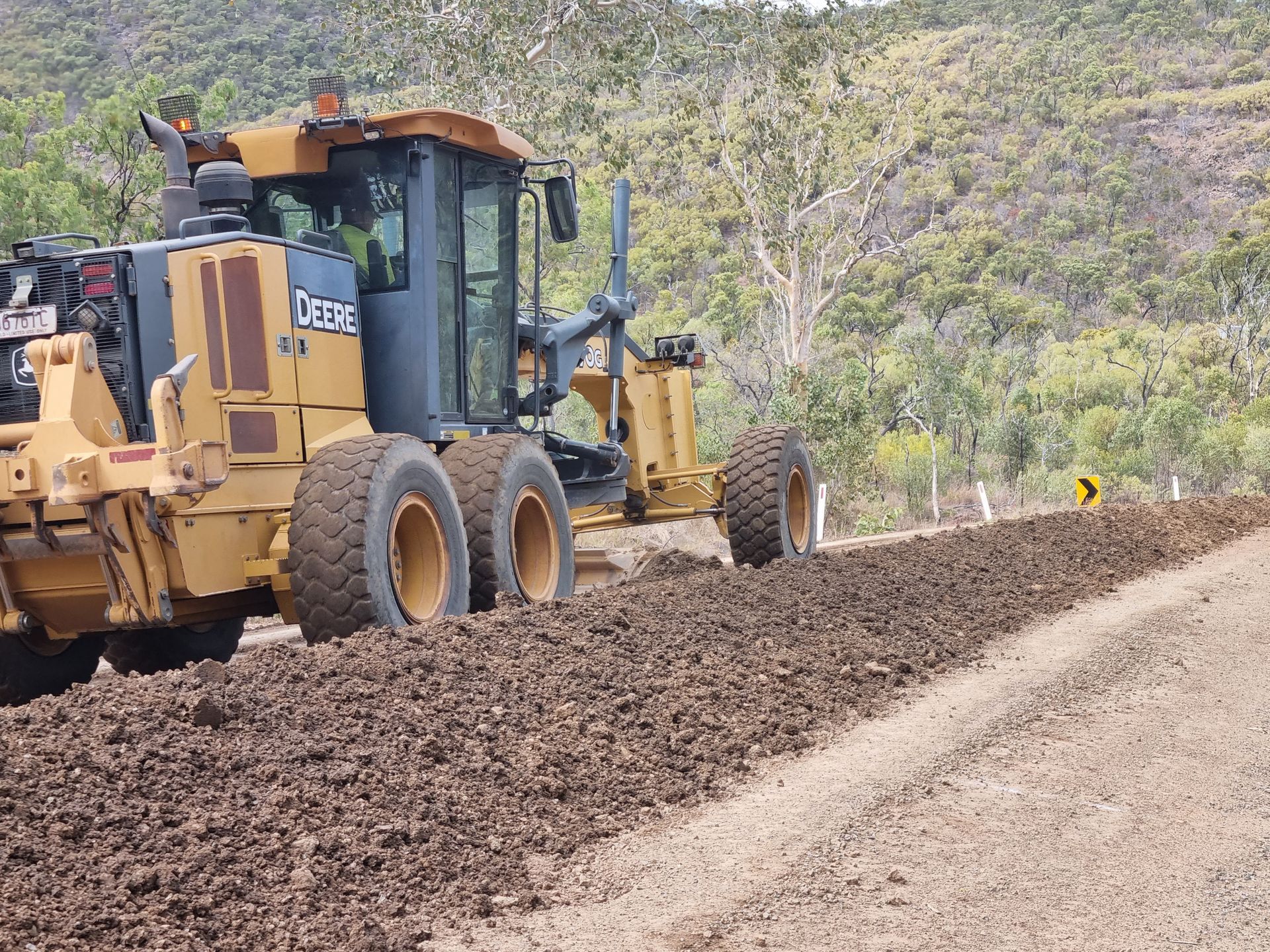 Yellow Road Grader Smoothing Dirt Along a Road — DJ Brazil Pty Ltd in Bowen, QLD
