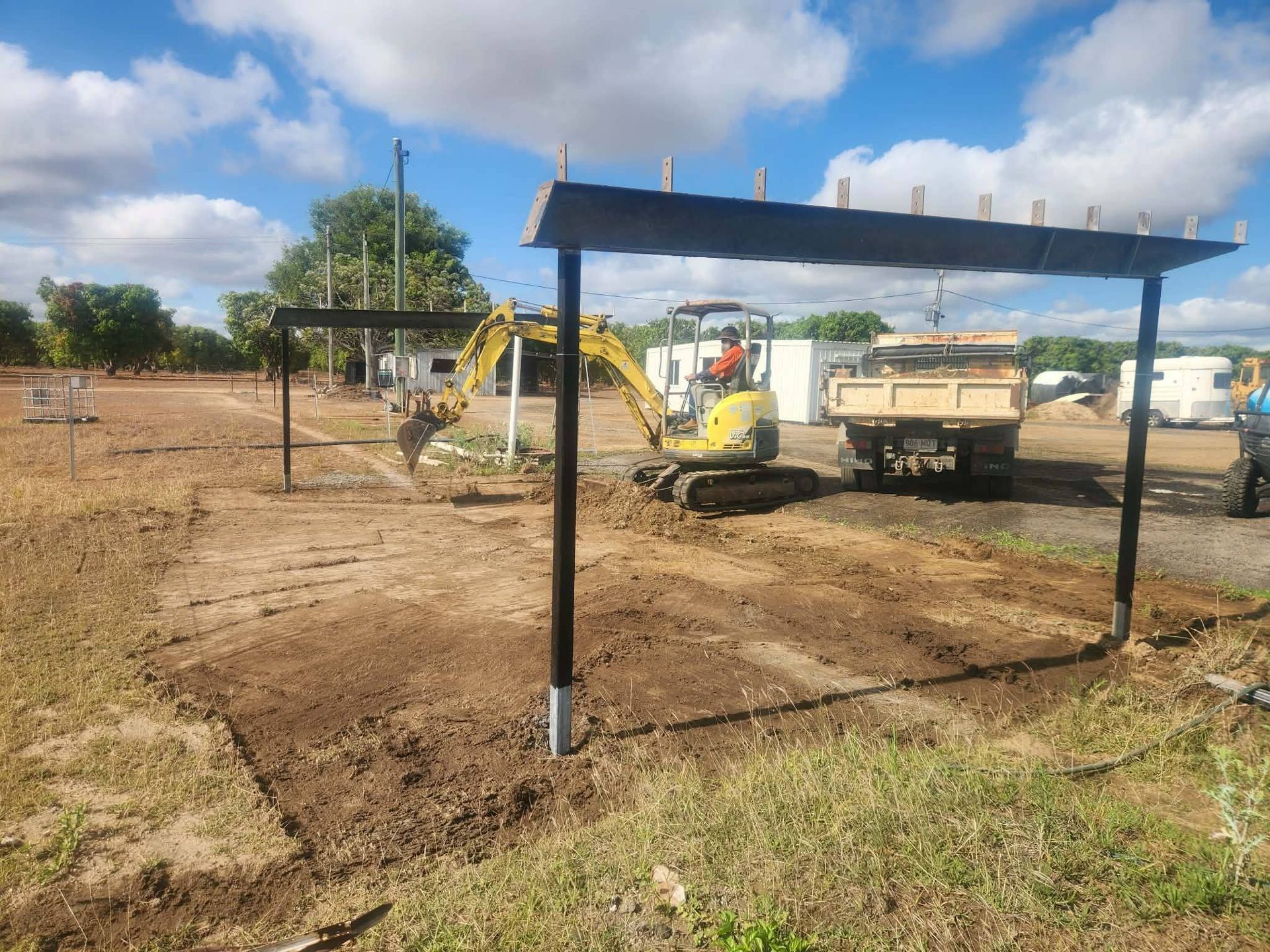 Yellow Excavator Digging Dirt — DJ Brazil Pty Ltd in Bowen, QLD