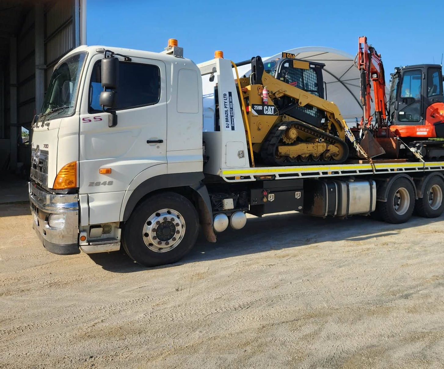 Tow Truck on Asphalt Road With Ramp Extended — DJ Brazil Pty Ltd in Bowen, QLD