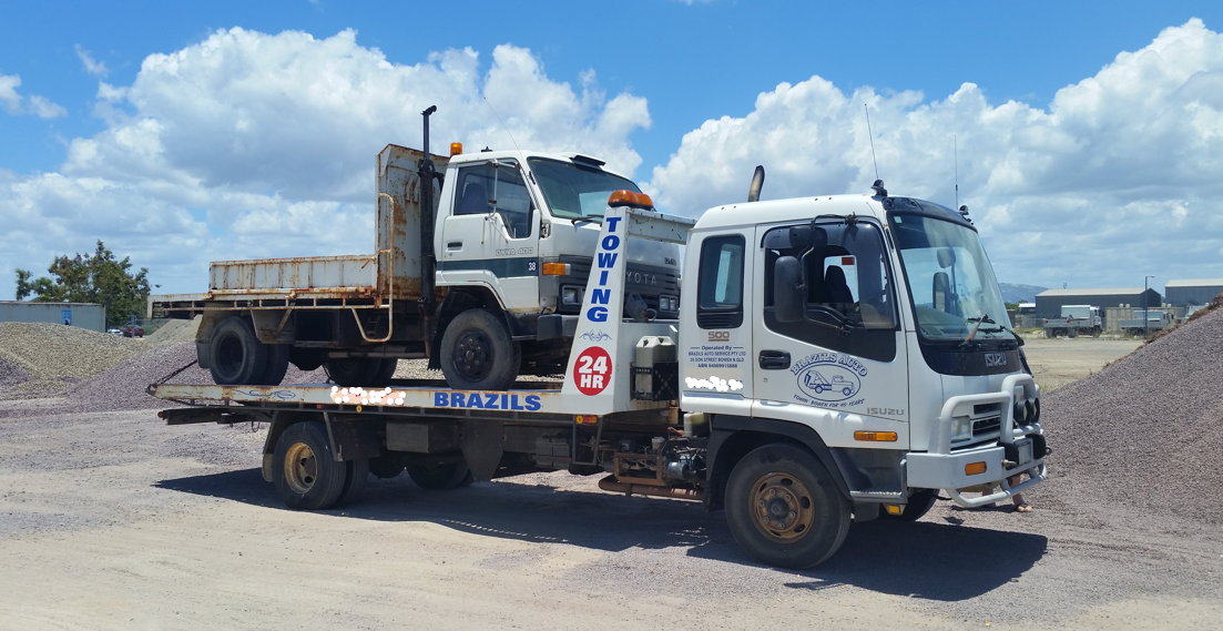 Tow Truck Carrying a Smaller Truck on Its Flatbed — DJ Brazil Pty Ltd in Bowen, QLD