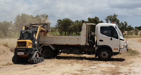 Tow Truck Loading a Teal Car on a Wet Street Next to a Green Bush — DJ Brazil Pty Ltd in Bowen, QLD